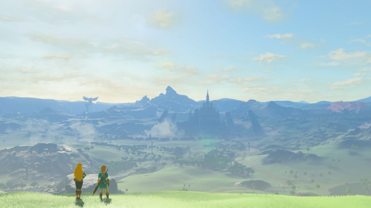 A screenshot of The Legend of Zelda: Breath of the Wild, showing Link and Zelda standing on a plateau and overlooking a busy forested valley beneath a cloudy sky.