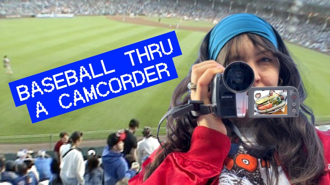 Video preview thumbnail entitled "Baseball thru a camcorder," with Lucius recording Wrigley Field through a Sony digicam with a superimposed Chicago hot dog.