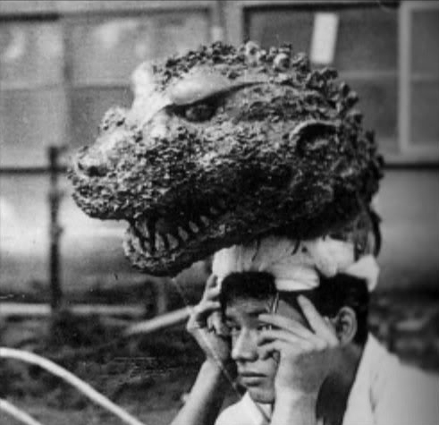 Gojira head on top of a human's head