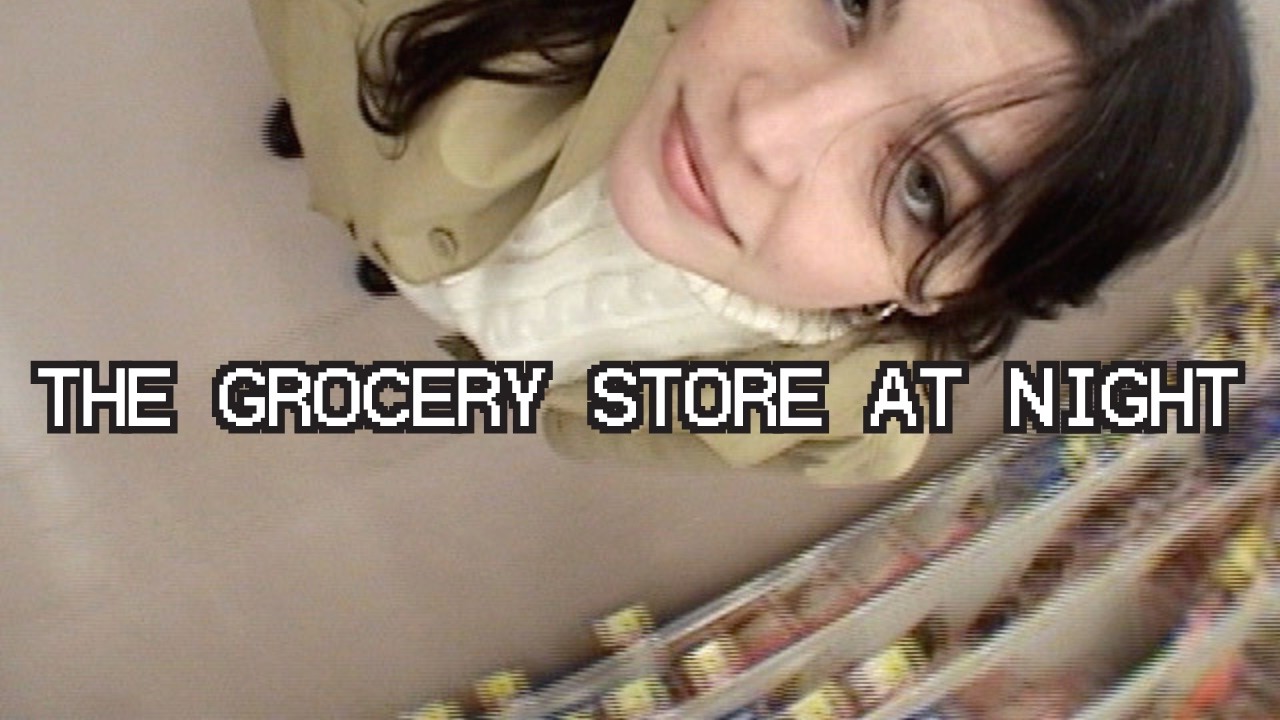Video thumbnail of Lucius recording herself from above in the soup aisle, entitled "The Grocery Store at Night."
