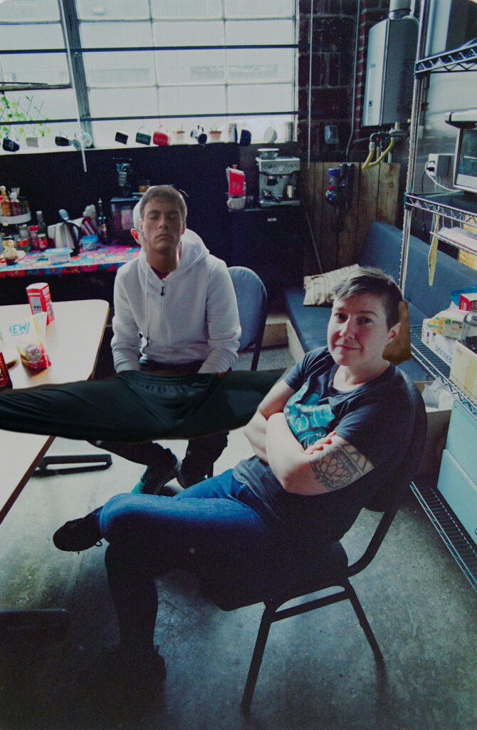 Erika and Matt, sitting in the galley area of Helioscope Studio, except Matt has Jean-Claude Van Damme's face and legs.
